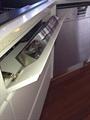 Stainless steel sink front tray uses otherwise wasted space between sink and front of cabinets